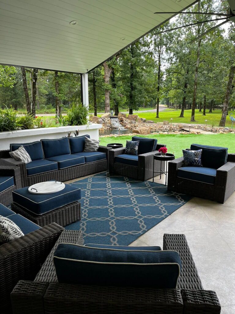 Covered porch area with couches near the pond